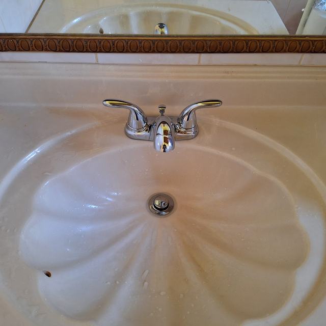 Shell-shaped bathroom basin with tap